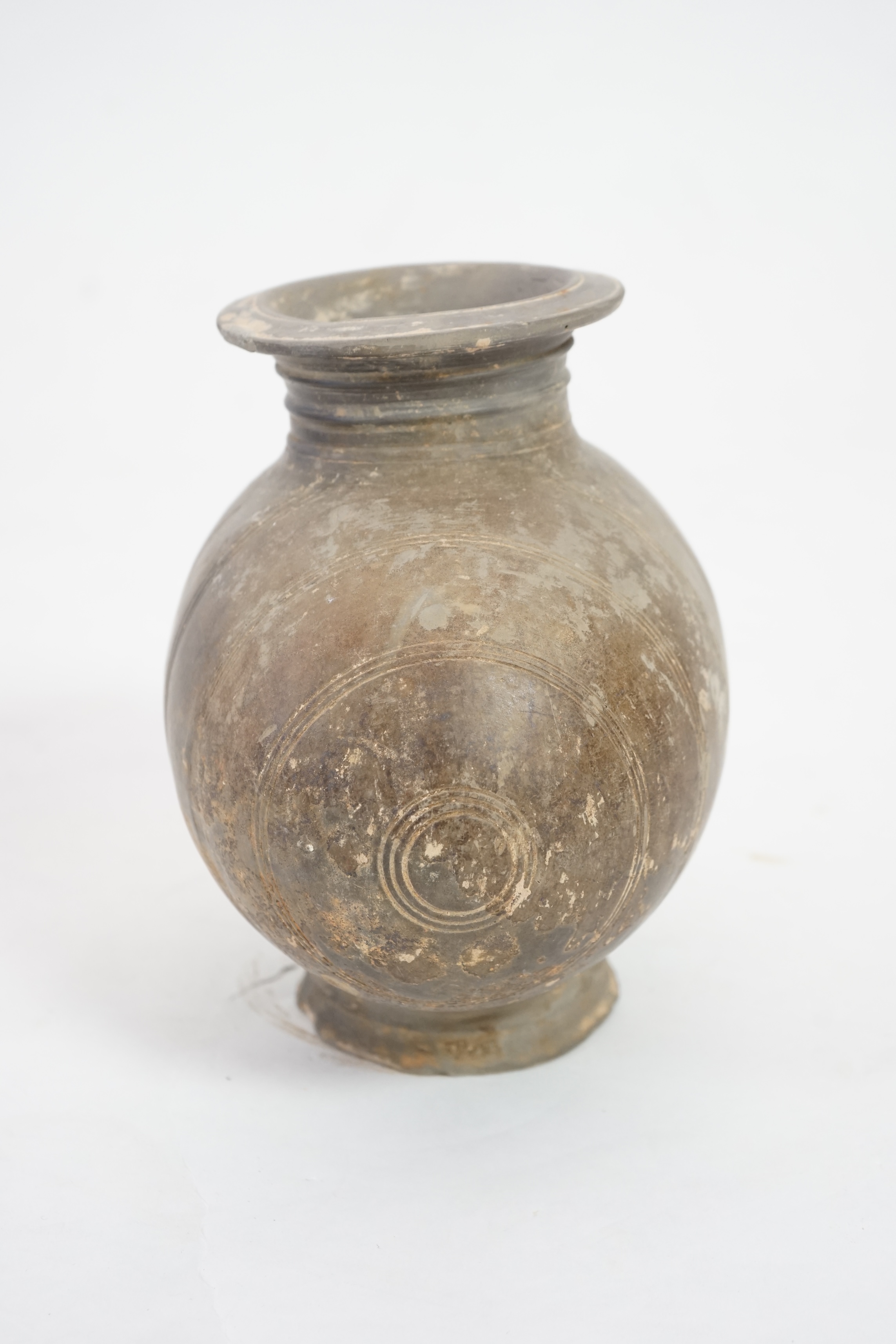 A Chinese incised and burnished pottery cocoon jar, Western Han Dynasty (206 BC-AD 8)